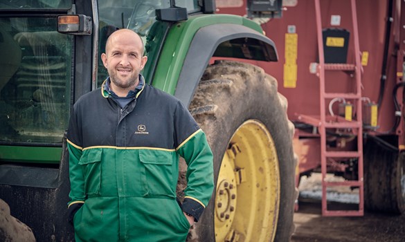 a man standing next to a tractor